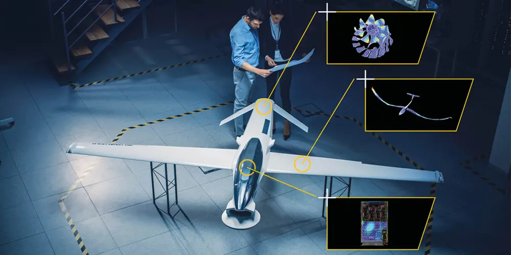 Aerial view of engineers examining a large drone model with detailed technical overlays of propeller, wiring, and circuitry components.