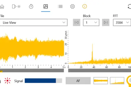 Real-time vibration signal and FFT analysis displayed on Polytec monitoring software for industrial acoustic quality control.